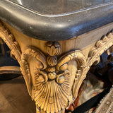 Stunning continental carved center table with shaped stone top.